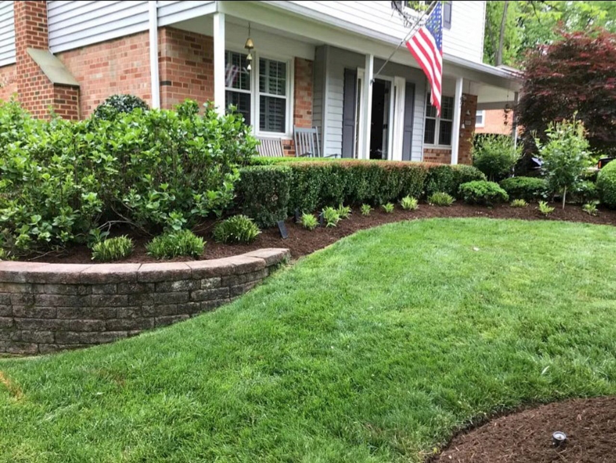 Landscaper trimming overgrown bushes